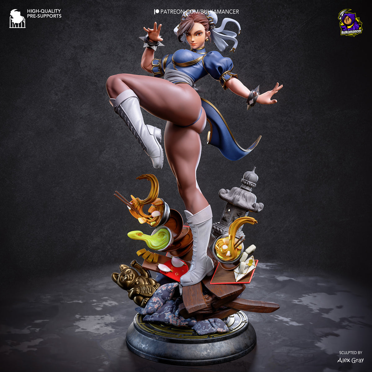 A detailed collectible statue of Chun-Li in a dynamic kicking pose, mounted on a decorative base with a lantern and rocks. The figure wears a blue and white outfit with gray boots and headpiece.