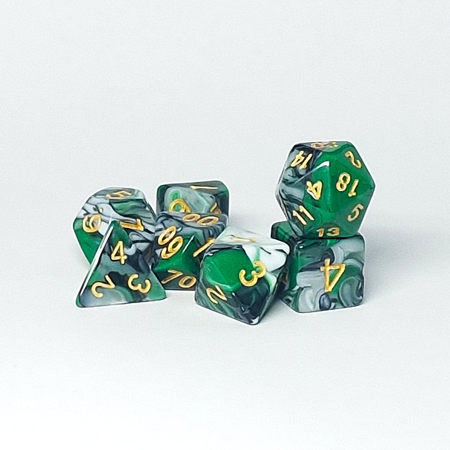 Set of green and gray marbled dice with gold numbers on a white background