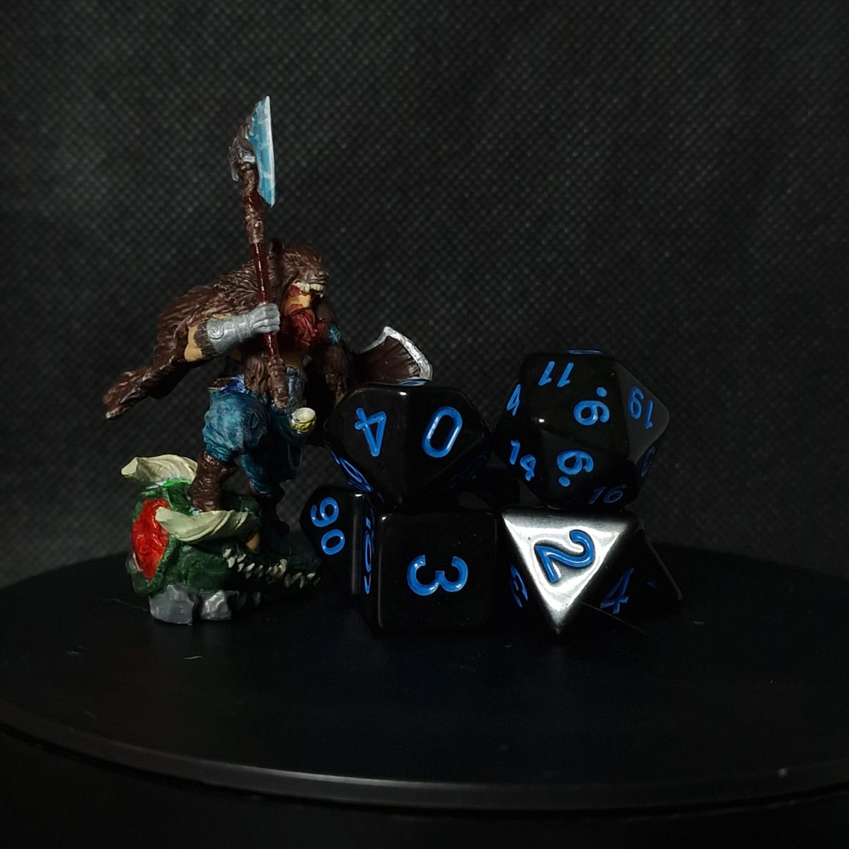 Black and blue Dungeons and Dragons dice set on a dark background