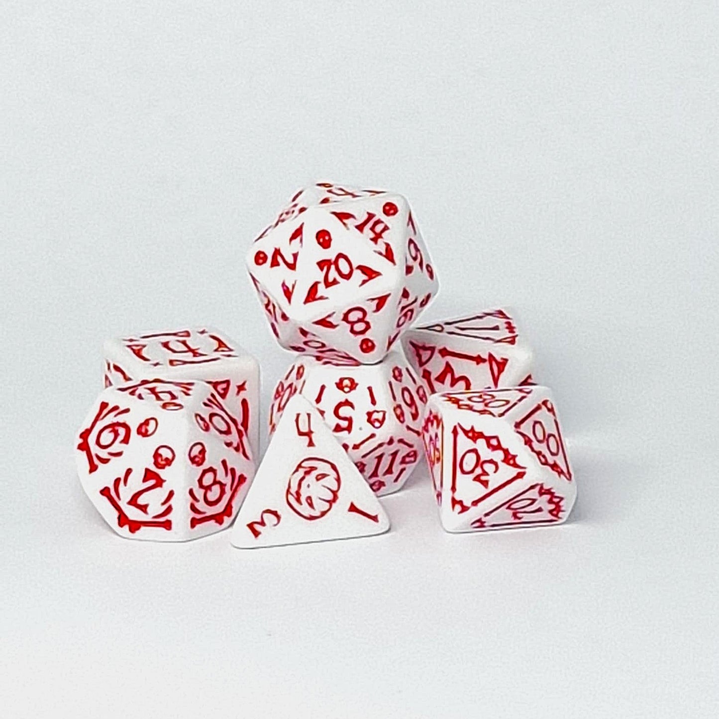 Set of white dice with red patterns on a light gray background