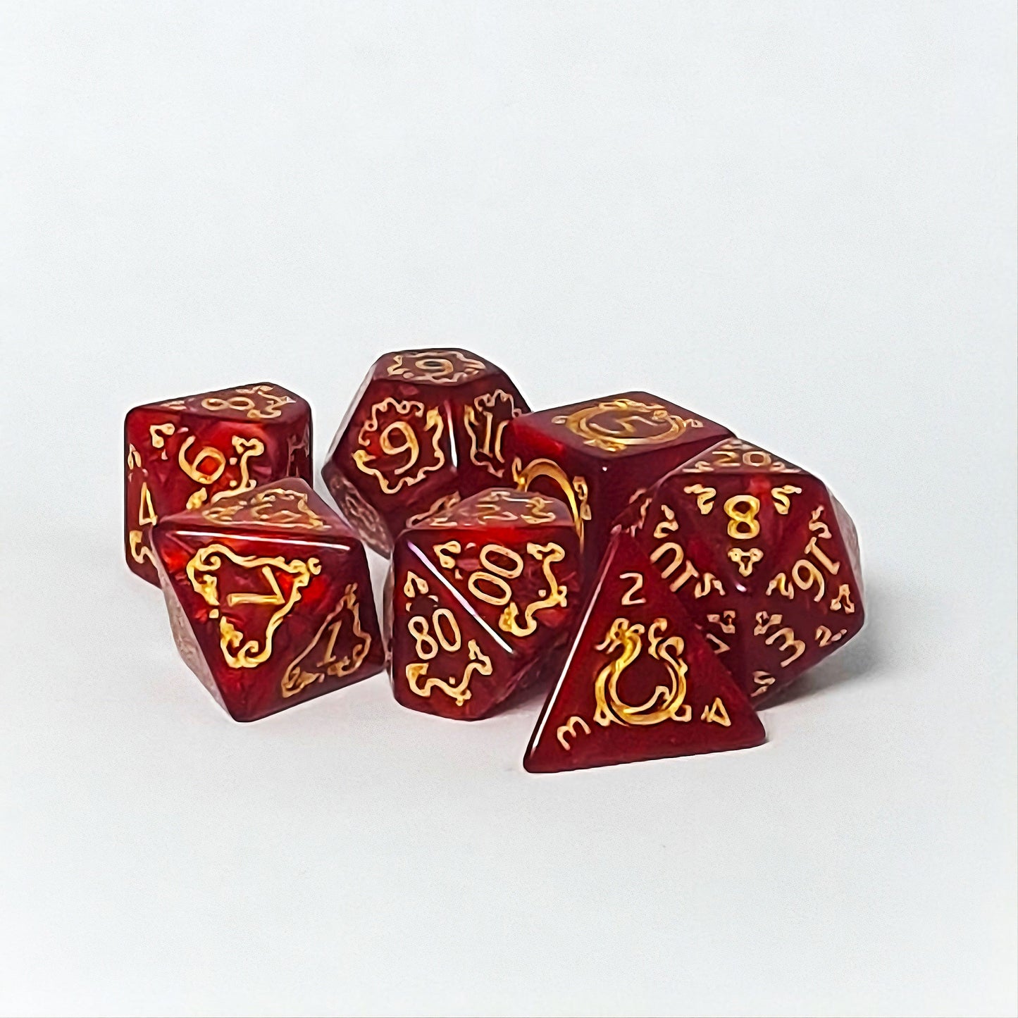 Set of red dice with gold patterns on a white background