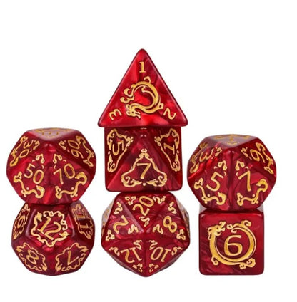 Set of red polyhedral dice with gold numbering and symbols on a white background