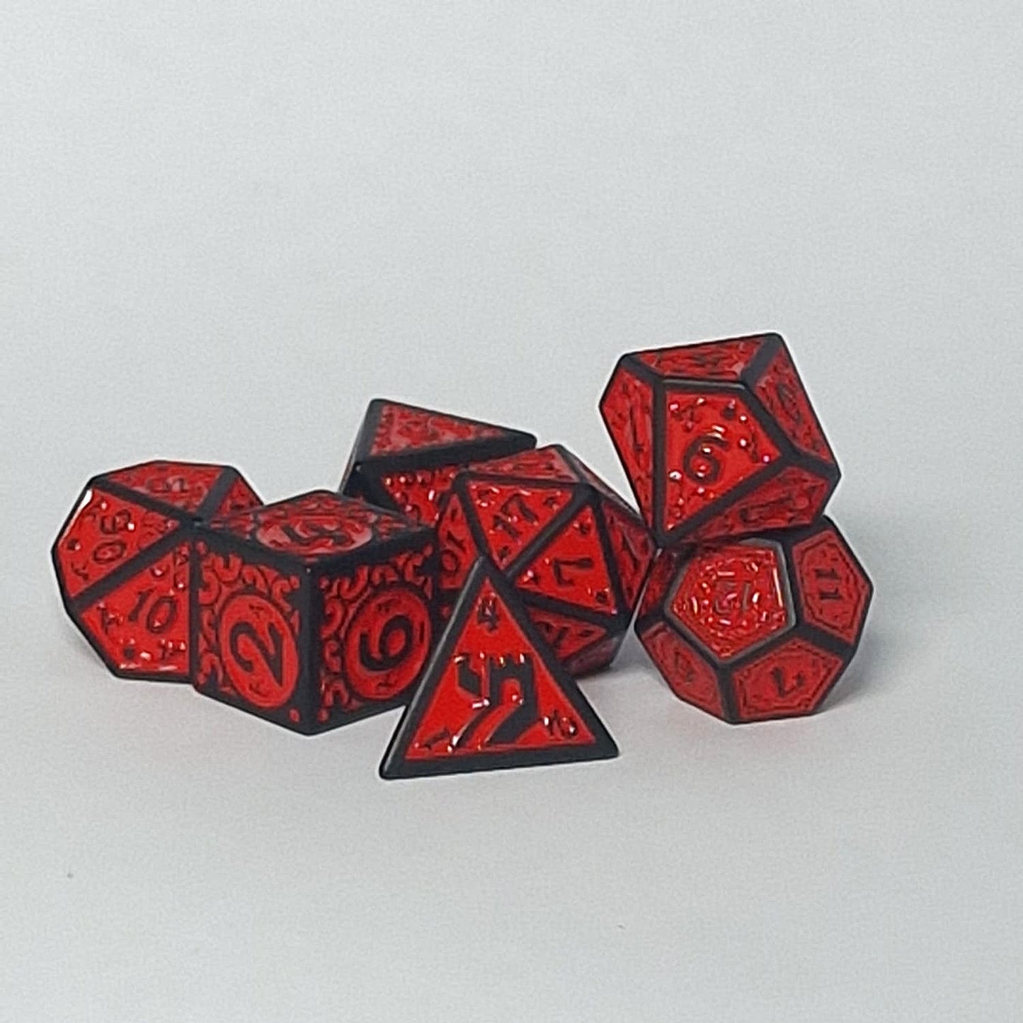 Red and black polyhedral dice set on a light gray background