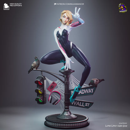 A stylized 3D-rendered collectible figure of a blonde female superhero in a black-and-white bodysuit with red accents, posed mid-leap on a street-lamp base with web details and a bird perched on the lamp, shown on a dark gray gradient background.