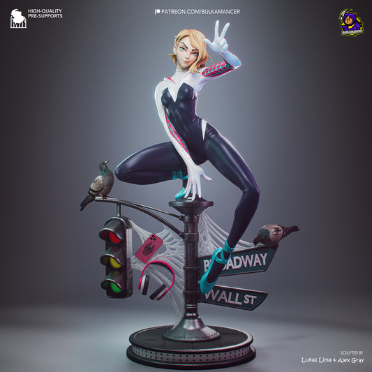A stylized 3D-rendered collectible figure of a blonde female superhero in a black-and-white bodysuit with red accents, posed mid-leap on a street-lamp base with web details and a bird perched on the lamp, shown on a dark gray gradient background.